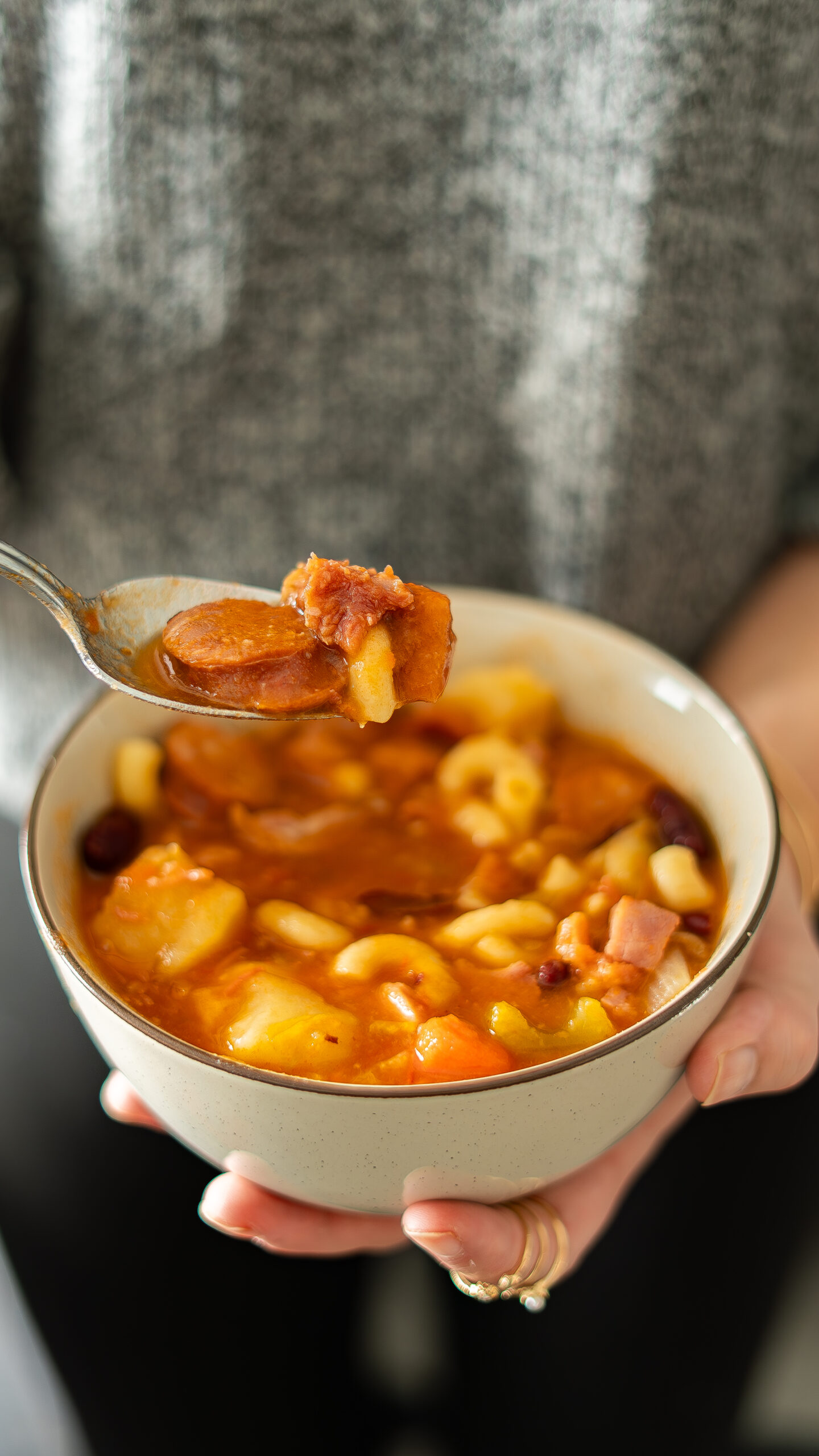 holding a bowl of portuguese bean soup