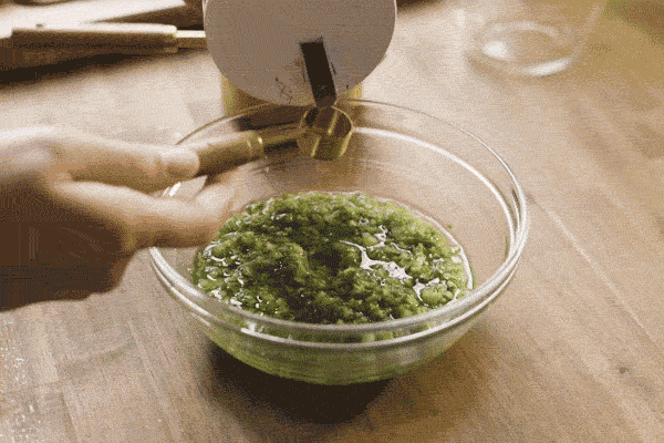 ginger scallion sauce is poured into a bowl then poured onto cold chicken.