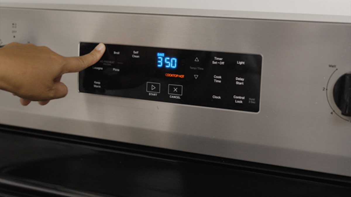 Oven control panel showing 350°F as a hand selects the bake setting.