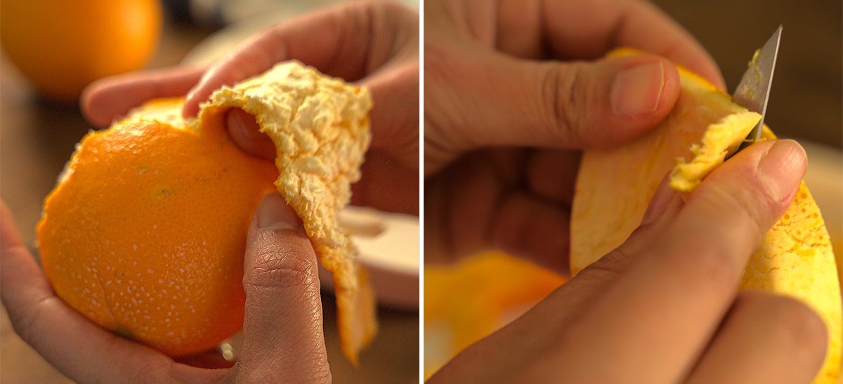 Hand scrubbing a whole orange under running water with a dark-bristled brush.
Right: Two whole oranges submerged in a large glass bowl of water.