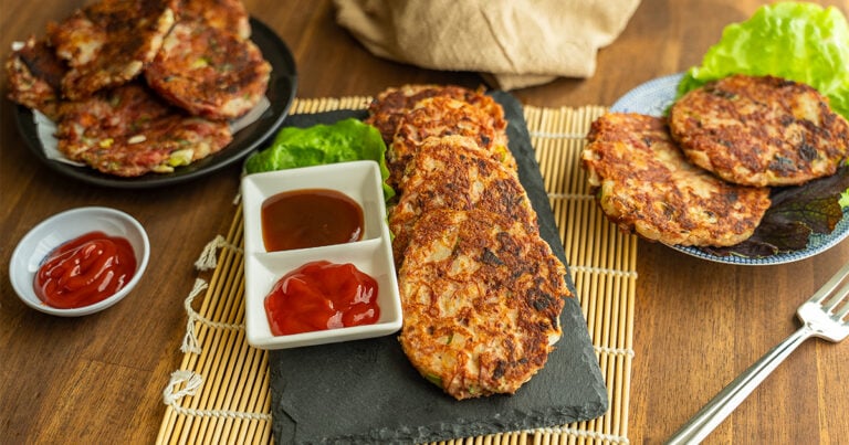 Okazuya-style corned beef hash patties on a slate board with ketchup and katsu sauce for dipping