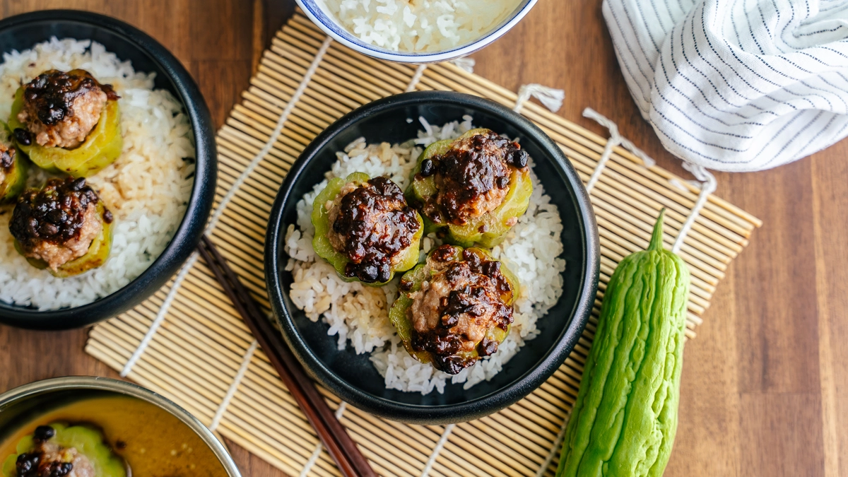 Three bowls of stuffed bitter melon with pork hash over rice, ready to serve
